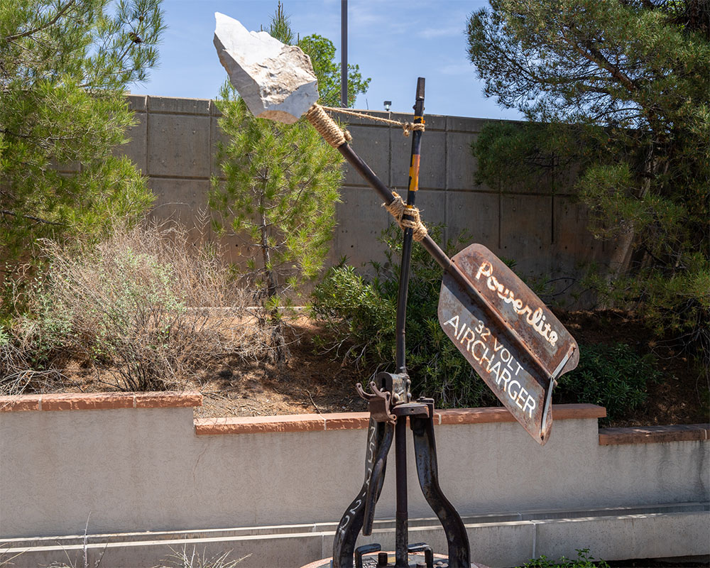 Courage at the Crossroads by Byron Ramos, 2025, marble steel and wood sail sculpture