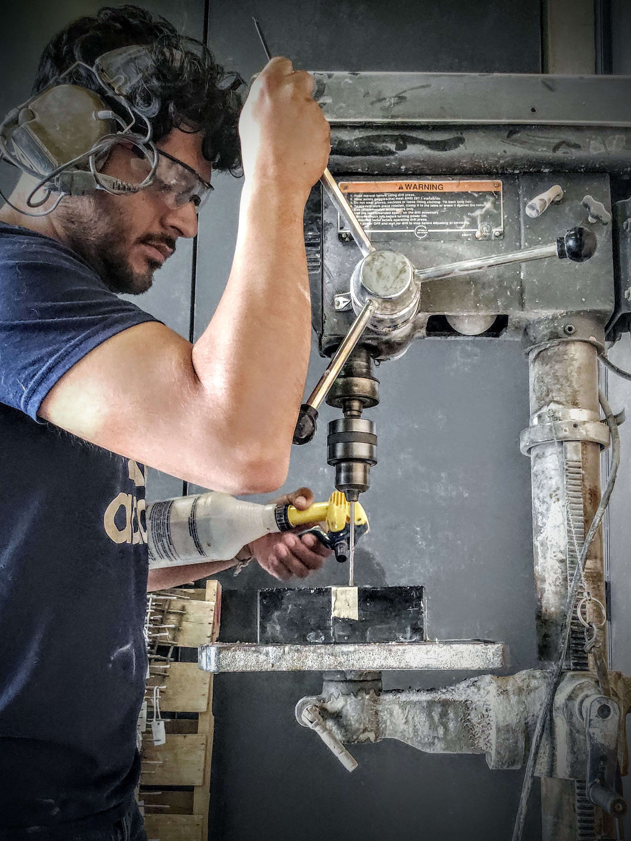 Using a drill press to make a black granite base, Utah fine artist sculptor Byron Ramos
