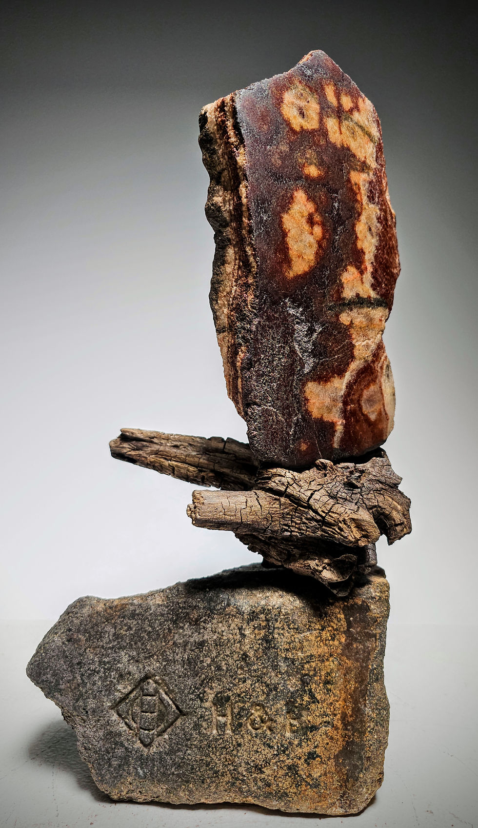 Thumbnail: Marbled red. brown, and pink stone sculpture sail with driftwood and foundry brick base by Utah Fine Artist Sculptor Byron Ra