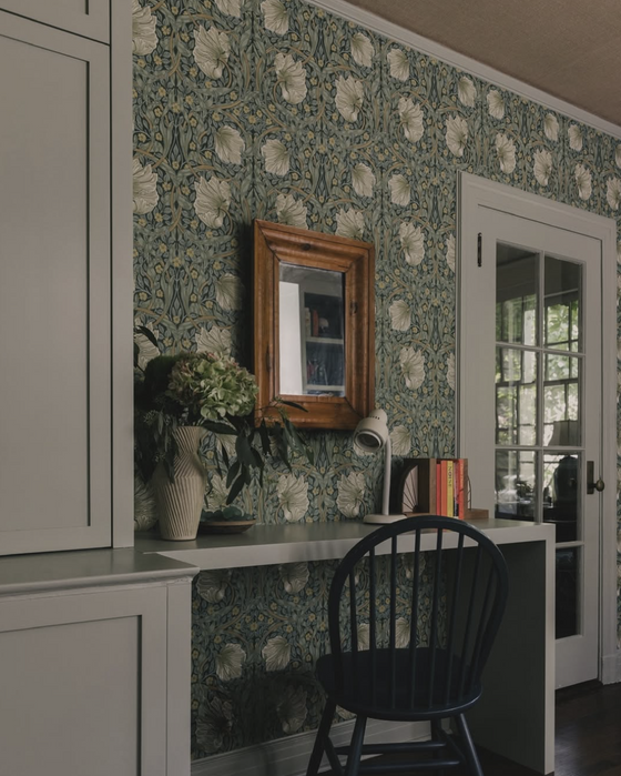Home study with custom painted cabinetry and a waterfall desk. 
