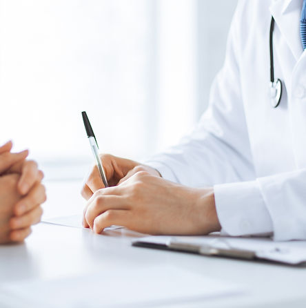 close up of patient and doctor taking notes.jpg