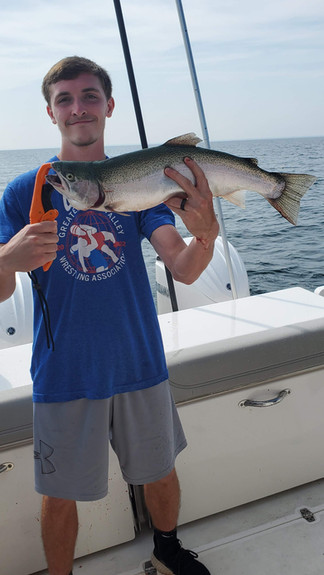 Boy in blue shirt holding a steelhead