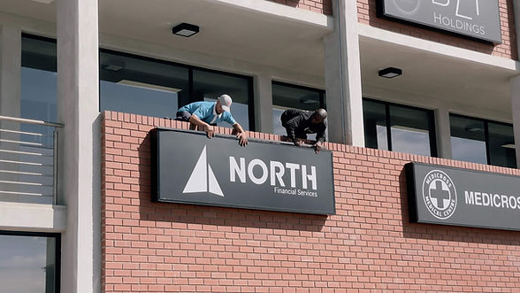 Installing North company sign on the new office building