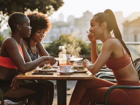 three women eating at outdoor cafe