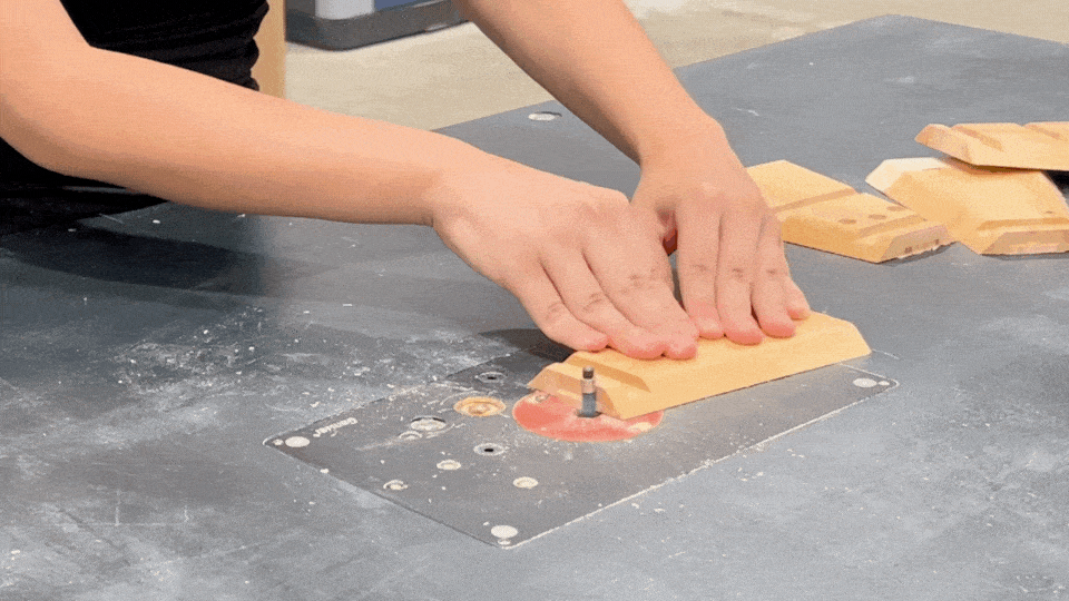 Using a router to chamfer the edges of wooden components, adding a professional finish to the lamp parts.