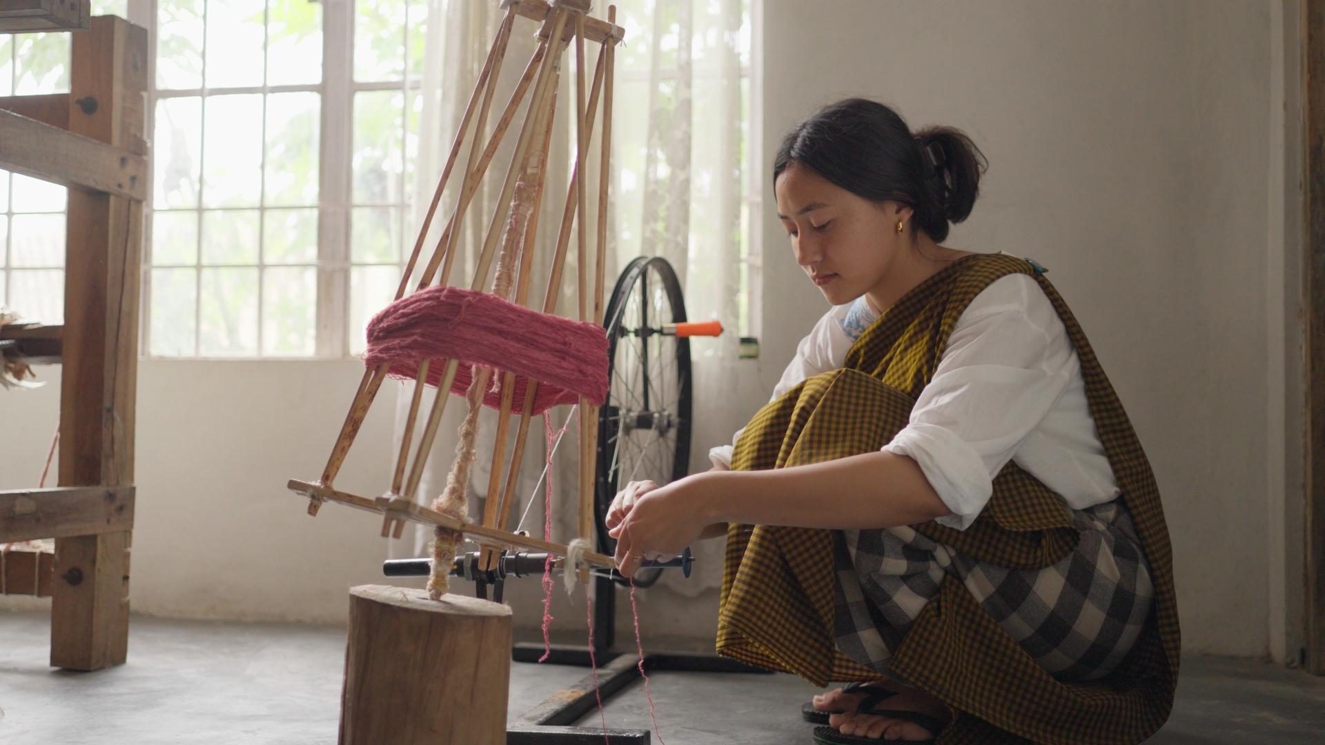 Woman operating a weaving machine