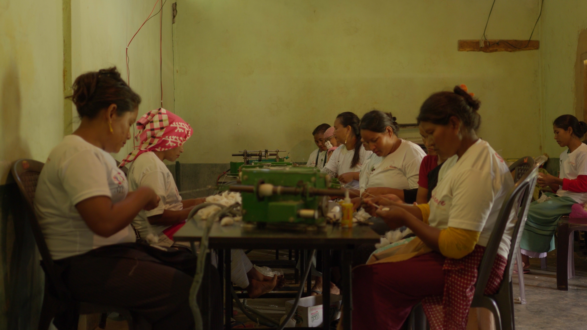 Women at work on a silk weaving machine