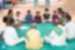 Community leaders and children discussing