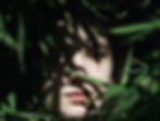 close-up-portrait-young-woman-amidst-leaves.jpg