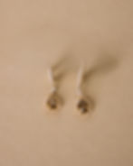 Golden Pear Diamond Earrings showcased on a taupe background