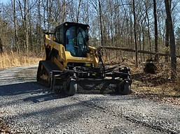 cat259d power rake grading driveway.jpg