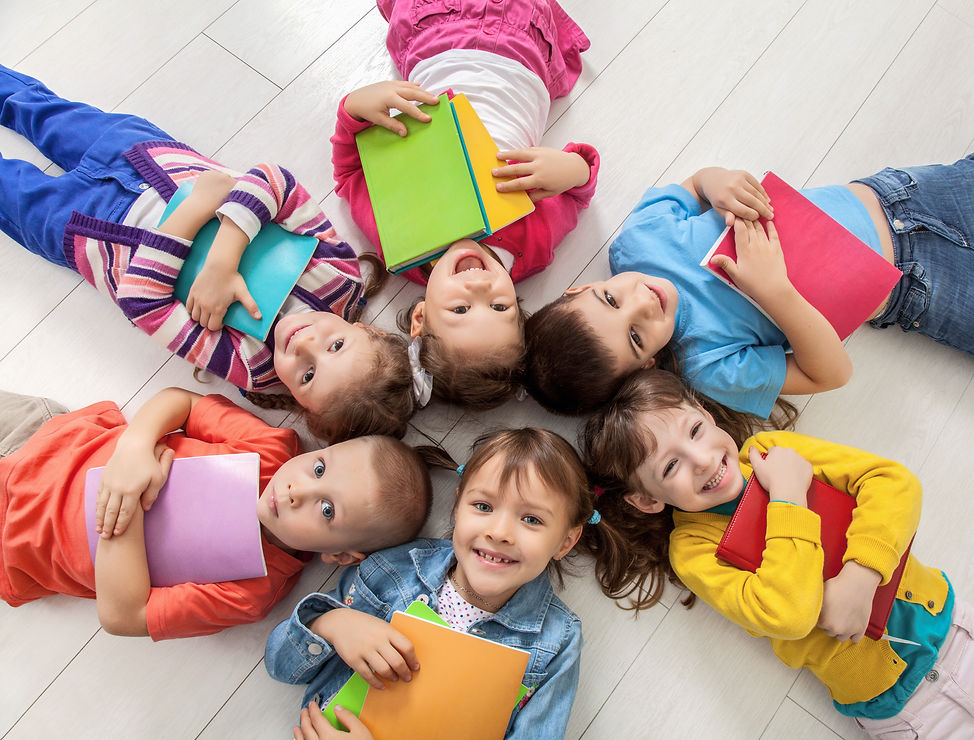 Kids smiling reading.jpeg