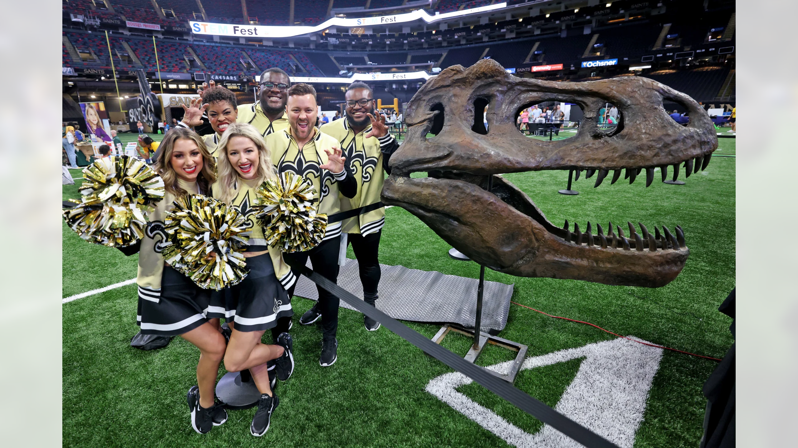 Saintsations meet T rex as part of The Dinosaur Experience dinosaur fossil display