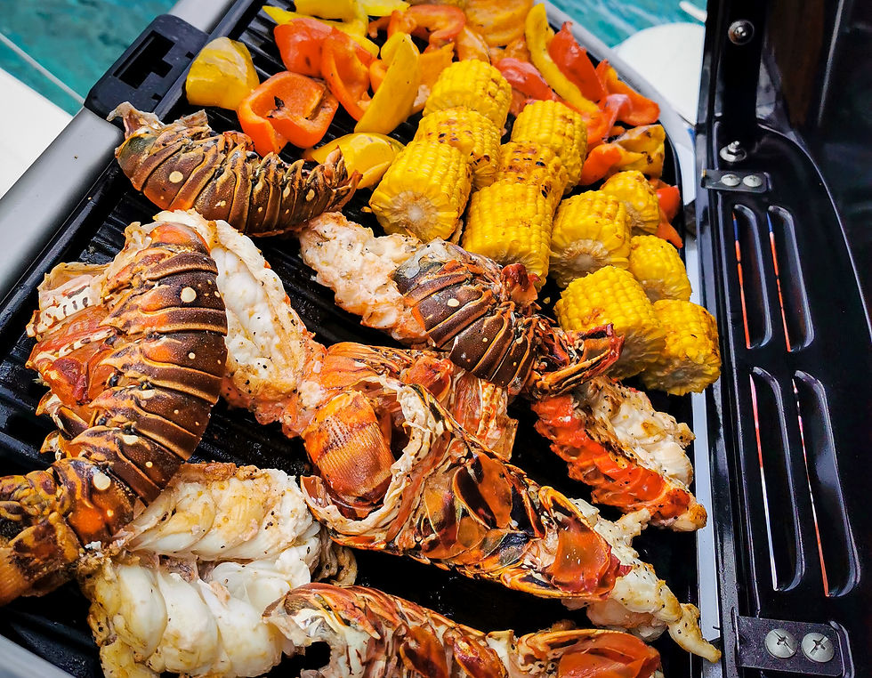 Lobster grilled with corn and peppers, grill onboard a catamaran from Cozumel Windseekers