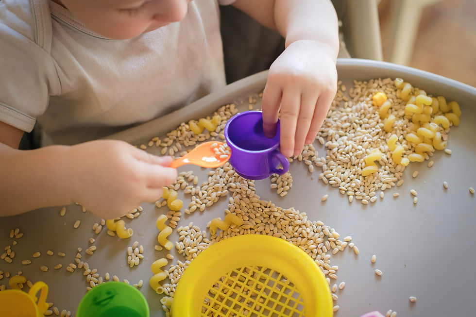 small kid pours toy yellow spoon ful in cup Games with products Montessori technique devel