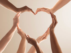 hands together creating an open heart shape