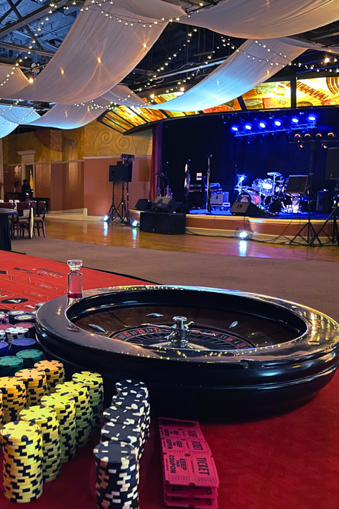 Roulette wheel with a stage set up for a band in the background