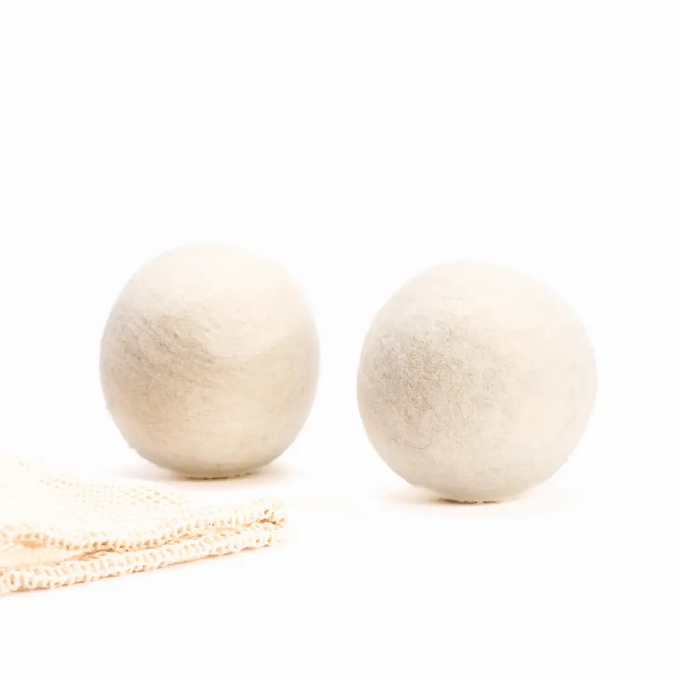 Thumbnail: Two natural wool dryer balls next to organic cotton mesh fabric.