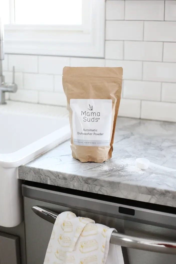 Thumbnail: Brown pouch MamaSuds Automatic Dishwasher Powder on kitchen counter.