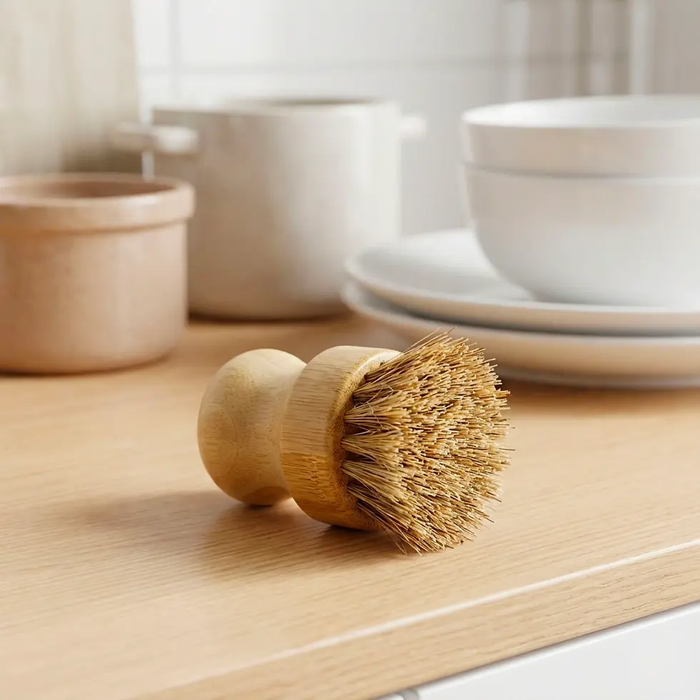 Thumbnail: Round bamboo dish brush with natural bristles on wooden countertop.