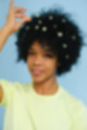 Photo of young woman with flowers in her afro