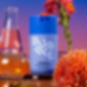 Blue 'BUBBLE Overnight Hydrating Sleep Mask' bottle with white text, next to laboratory flasks and a blooming orange flower against a purple backdrop.