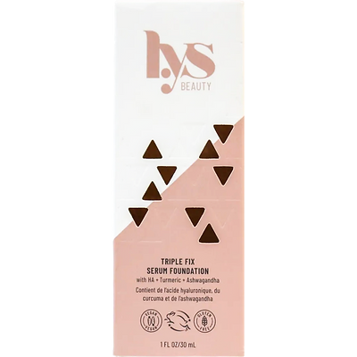 LYS Beauty's Triple Fix Serum Foundation has a sleek, tall pale pink box with black triangular patterns, highlighting its formula with HA, Turmeric, and Ashwagandha, in a 30ml size.