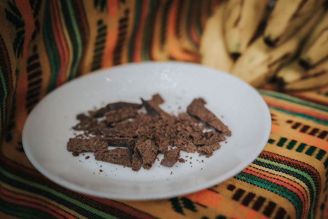 Offering of cacao during a welcome ceremony at Lunita Jungle Retreat Center in Cancún, Mexico, set against a colorful, traditional backdrop.