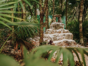 Stone structure surrounded by lush greenery at Lunita Jungle Wellness Retreat, representing the mystical Aluxes house.