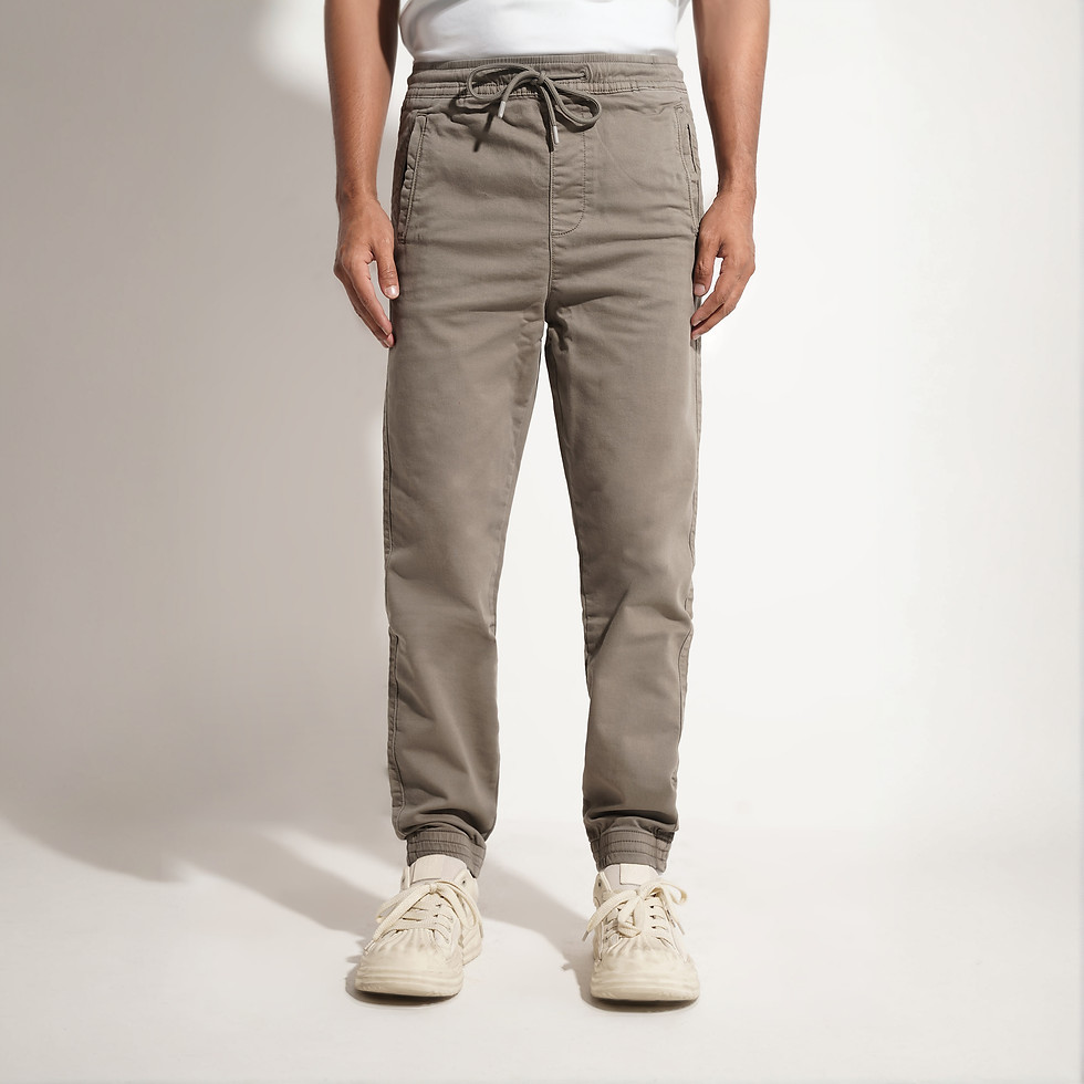Man in taupe joggers and white sneakers