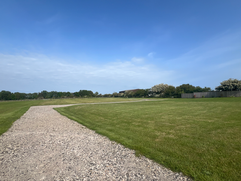 Gravel path through a green field