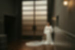 Hannah posing for her bridal portraits in a beautifully lit area of Wylam brewery