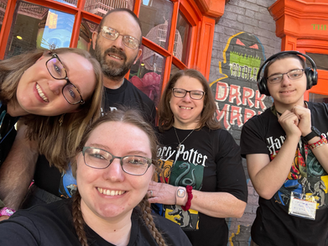 Family traveling with neurodiverse children at a theme park enjoying a quiet moment together