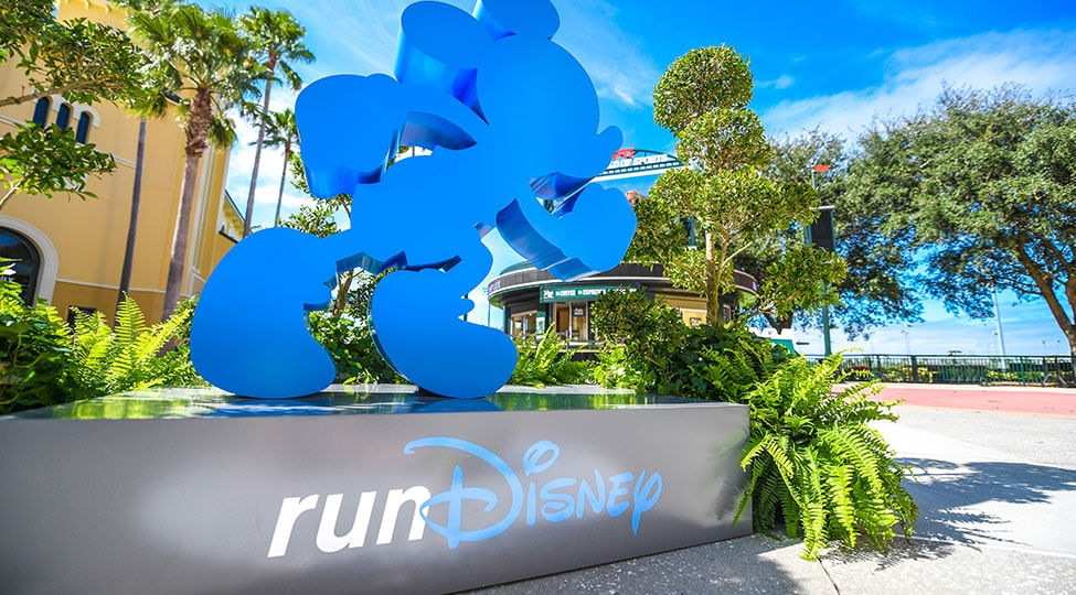 Large blue Mickey profile on top of gray stage with runDisney logo.