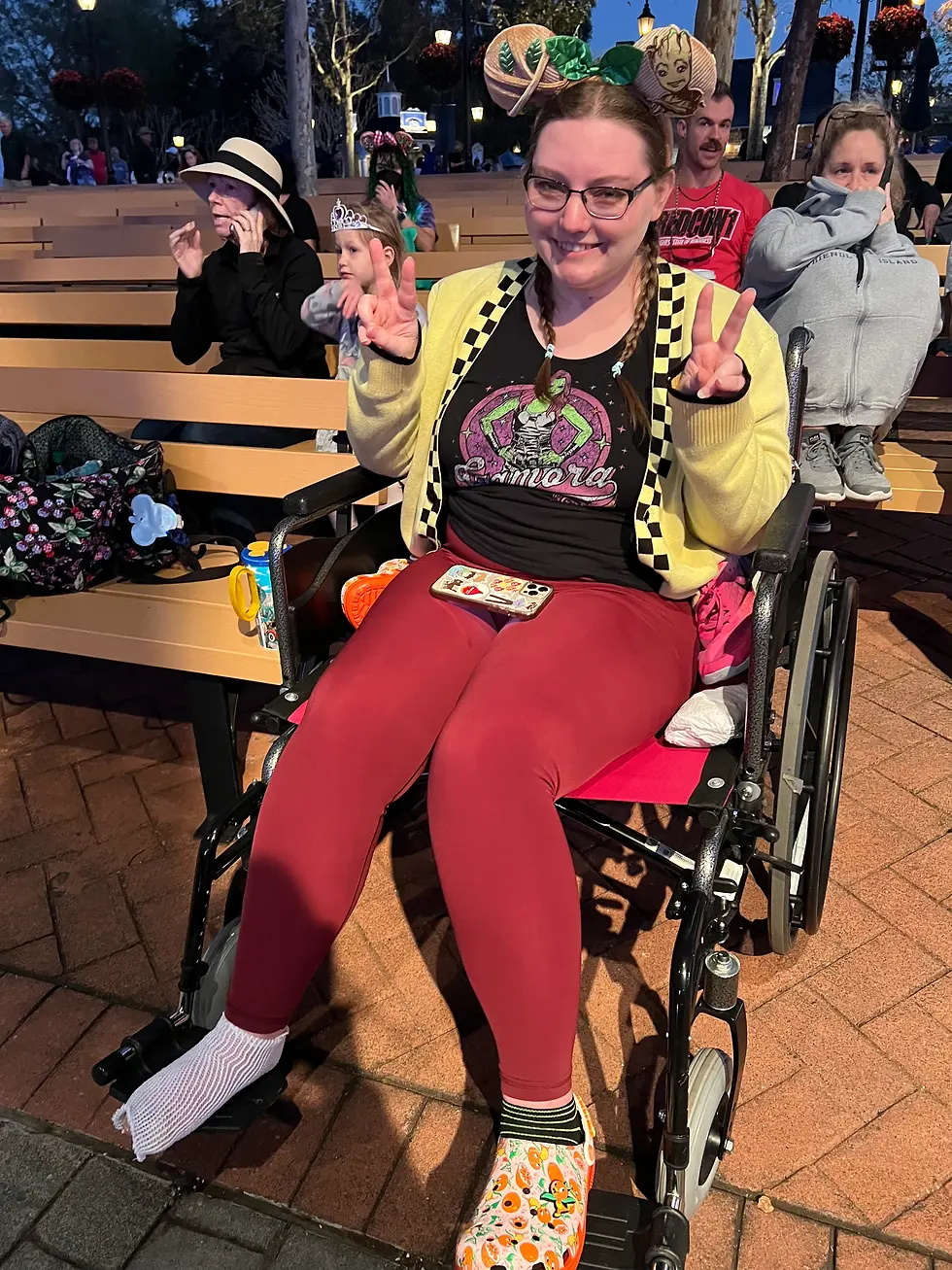 Kim in a wheelchair after hurting her foot at EPCOT