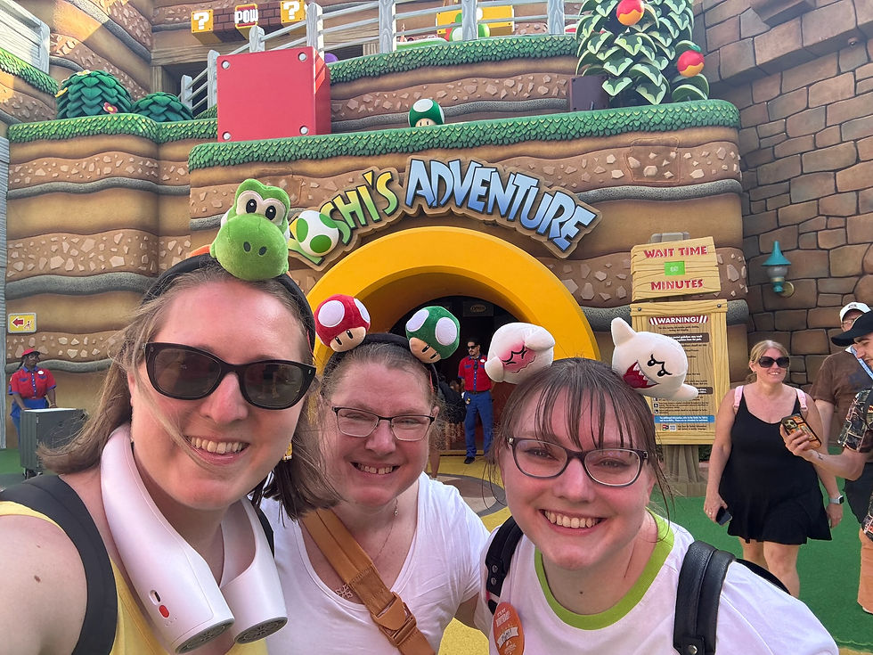 A family in front of Yoshi's Adventure at Epic Universe wearing Mario headbands and smiles