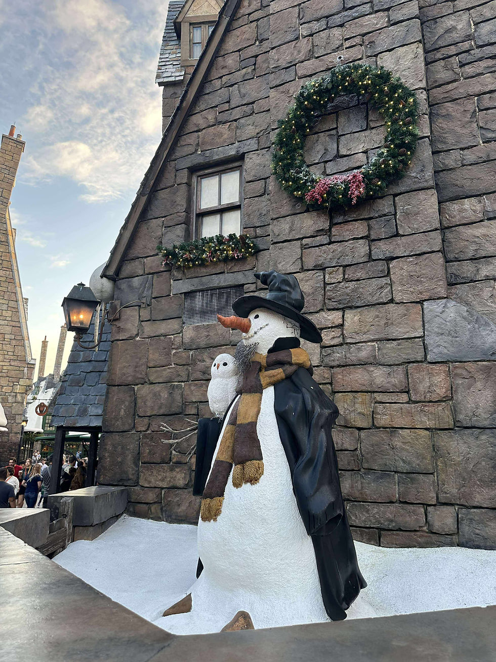 Hogsmead in Universal's Island of Adventure decorated in Christmas wreaths and Garland for 2025