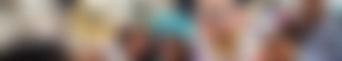 A family taking a picture with Mickey Mouse