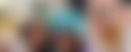 A family taking a picture with Mickey Mouse