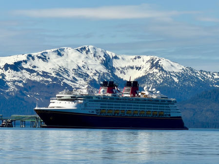 Disney Magic in front of a snowy mountain in Icy Point Straight near Hannah, Alaska