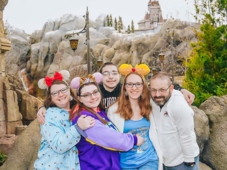 Family with autistic child at Cinderella’s Castle in Walt Disney World, making magical memories together