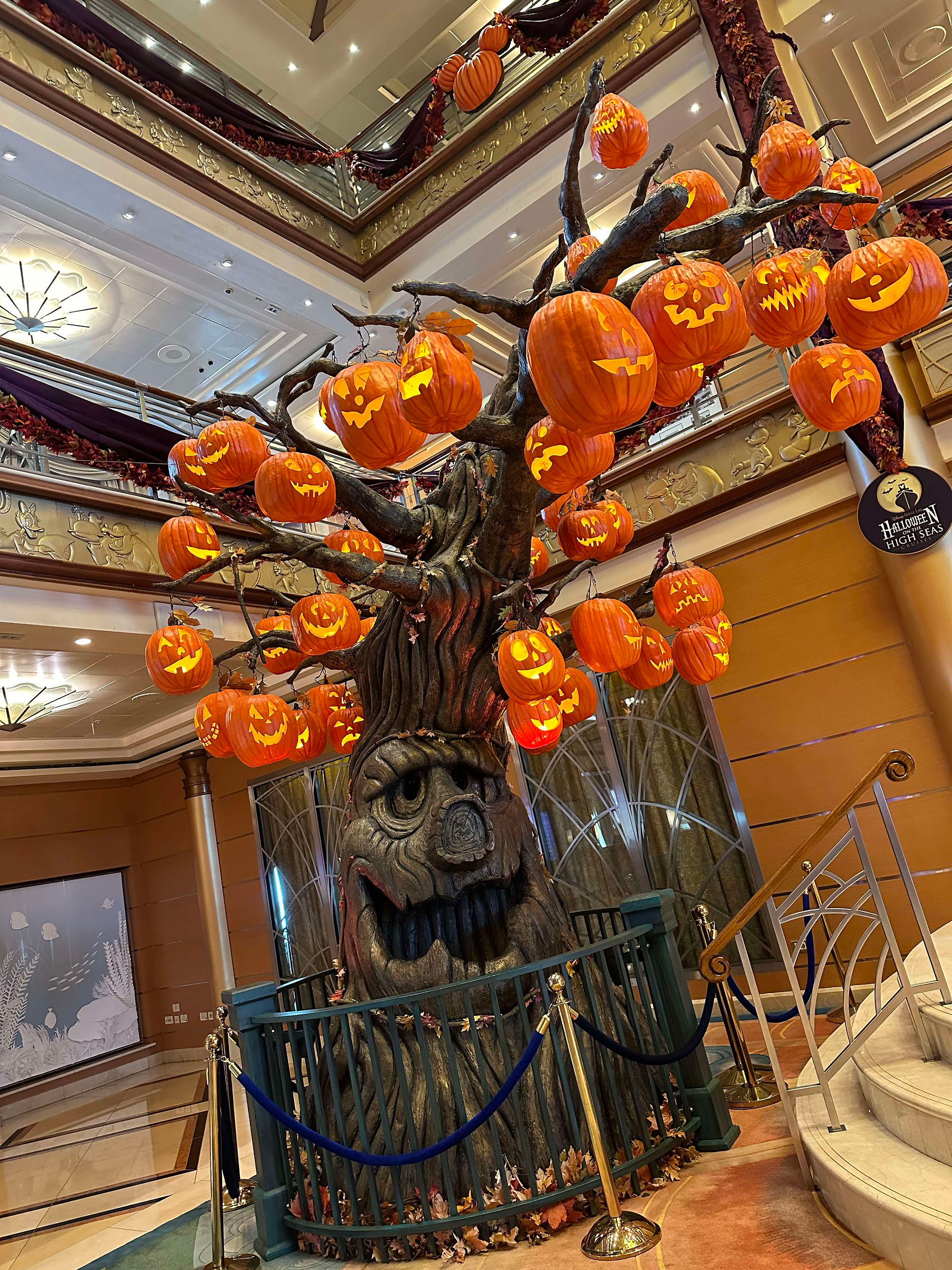 Halloween decor, a tree with a spooky face covered in hanging Jack-o-Lanterns Hal;pween on the High Seas