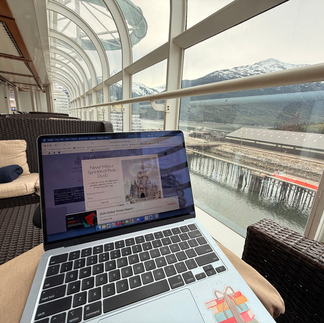 A computer showing the Practically Perfect Pixie Dust Web page with on the deck of the Disney Magic with Mountains in the Background