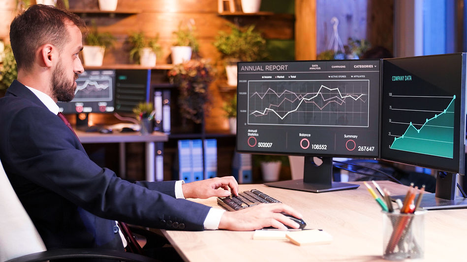 manager-working-office-two-monitors-evening-businessman-with-data-pc-screens.jpg