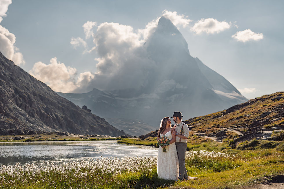 Real elopement couple standing above the Riffelsee with the Matterhorn in golden-hour light, Zermatt