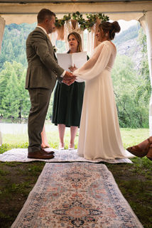 a man, woman and their officiant as they get married