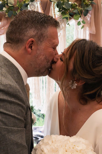 The bride and the groom sharing their first kiss as husband and wife