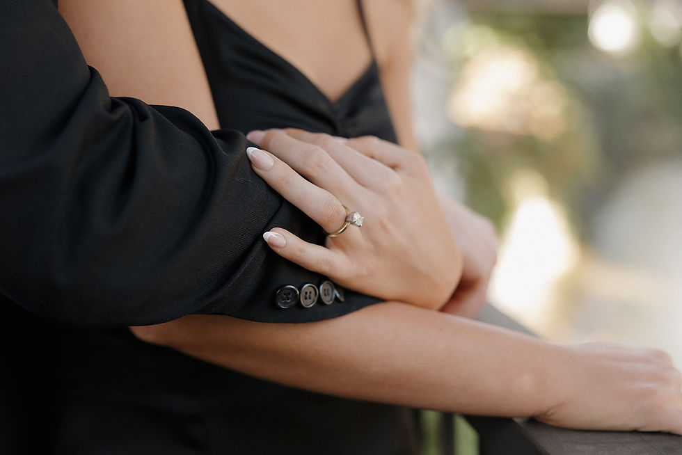 Bride-to-be’s ring sparkling under SLO city lights during engagement session
