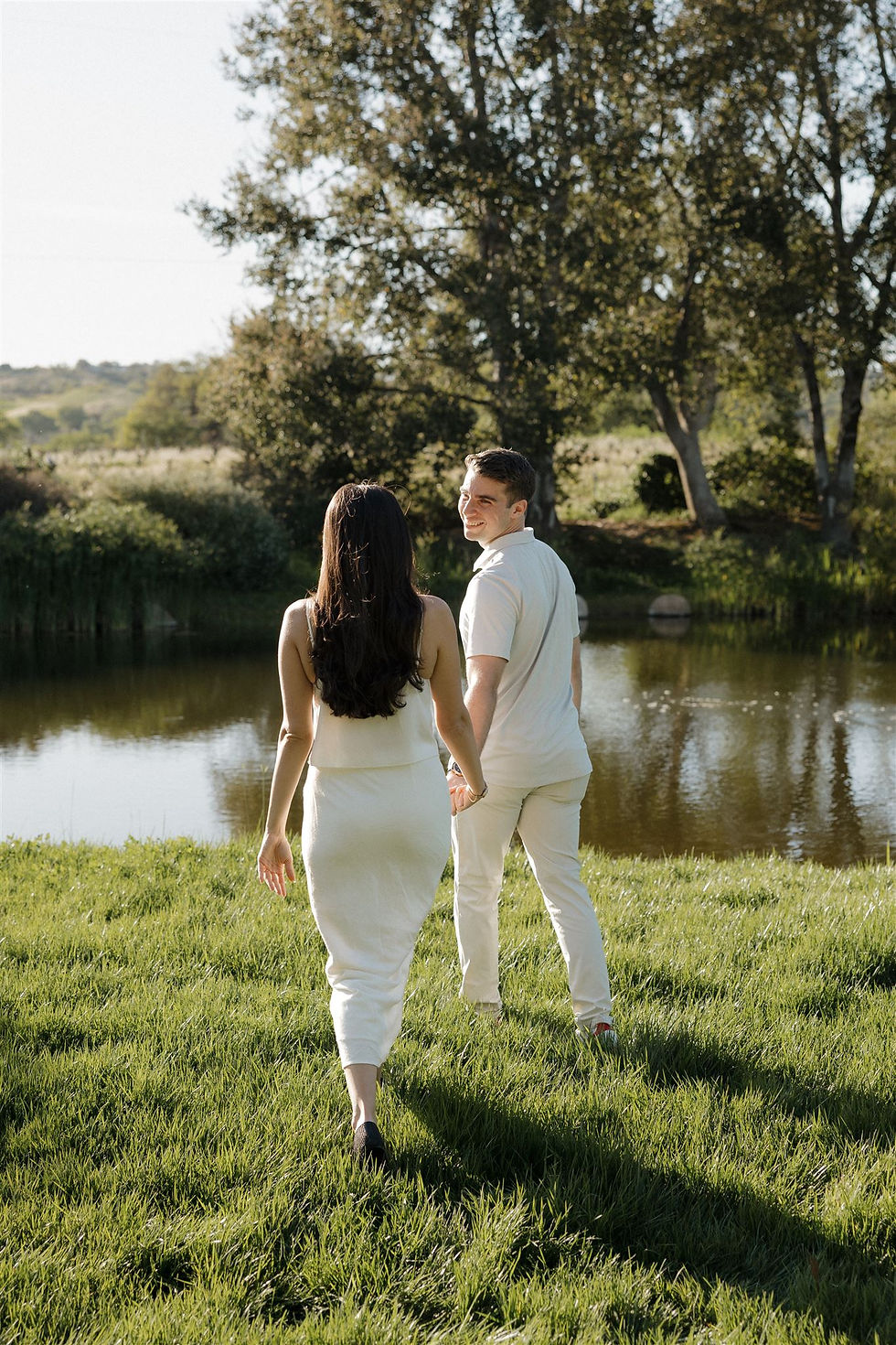 Romantic sunset engagement portrait of couple in wine country
