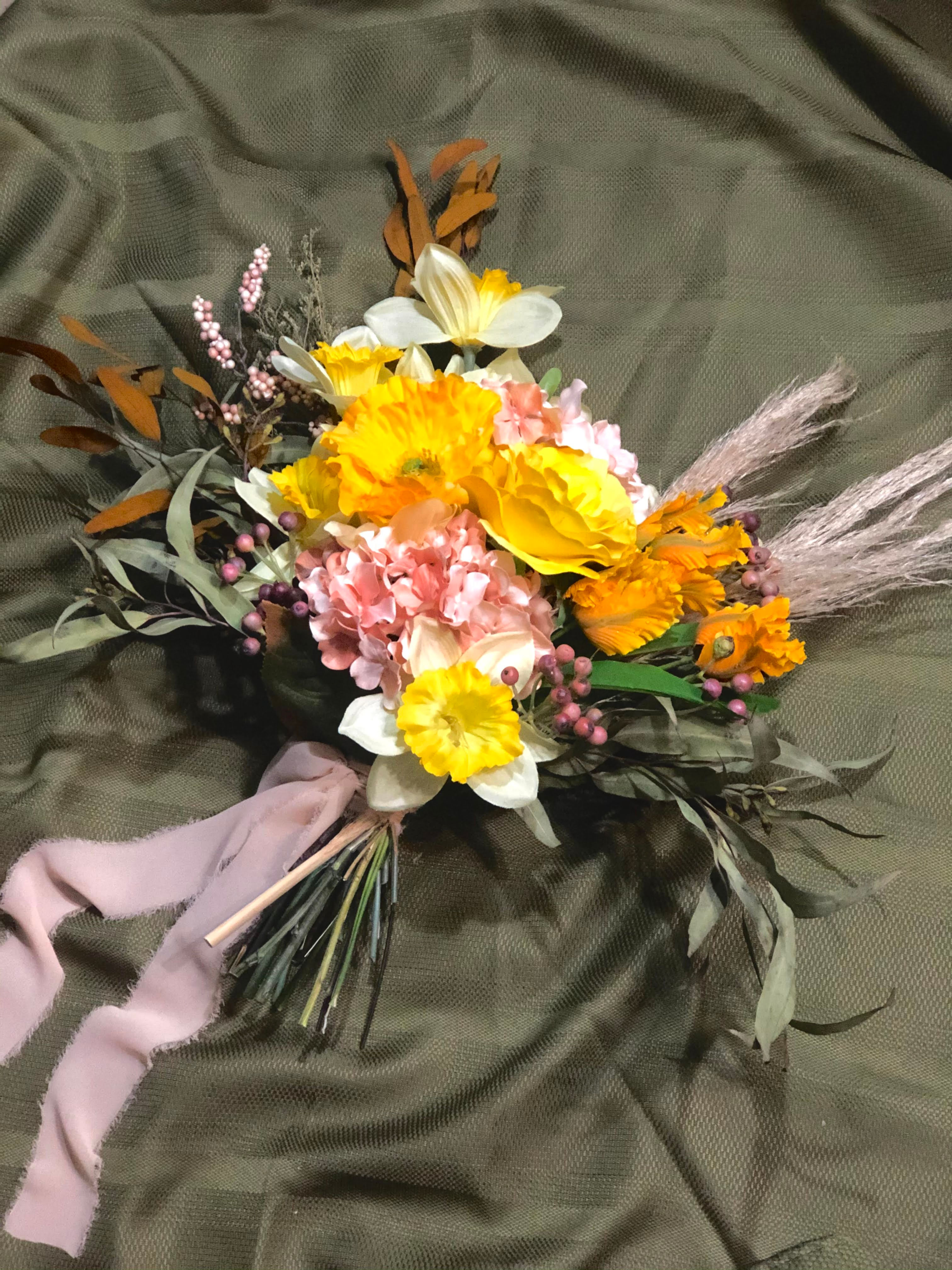 Bridal bouquet made of silk flowers and pampas grass.